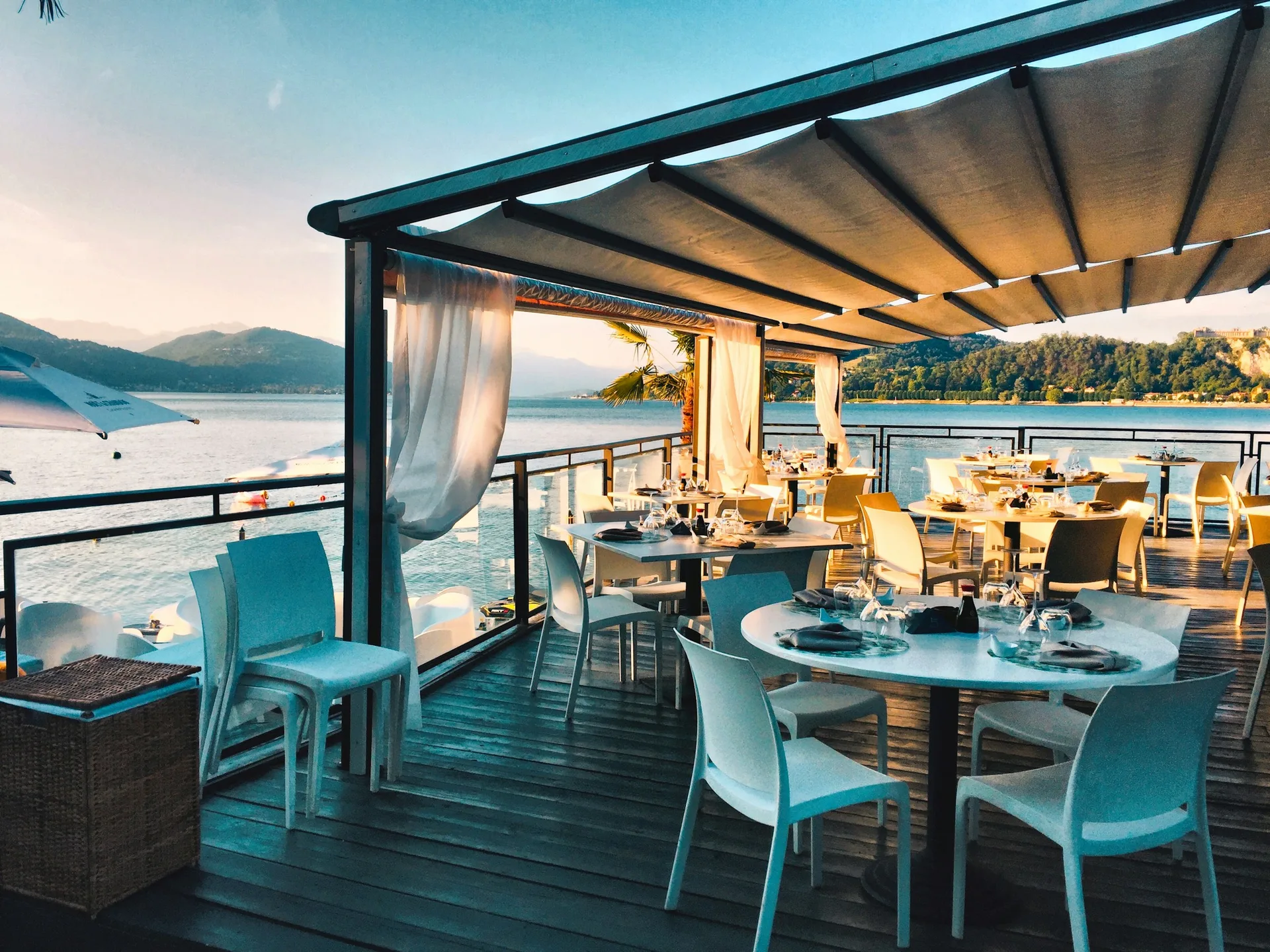 Boracay beachfront restaurant with set tables overlooking the ocean at sunset