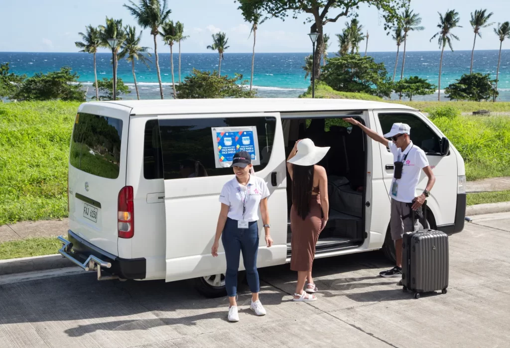 Guests boarding the shared transfer van with coordinators
