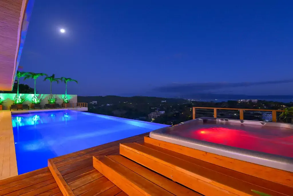 Heated jacuzzi beside the infinity pool at night